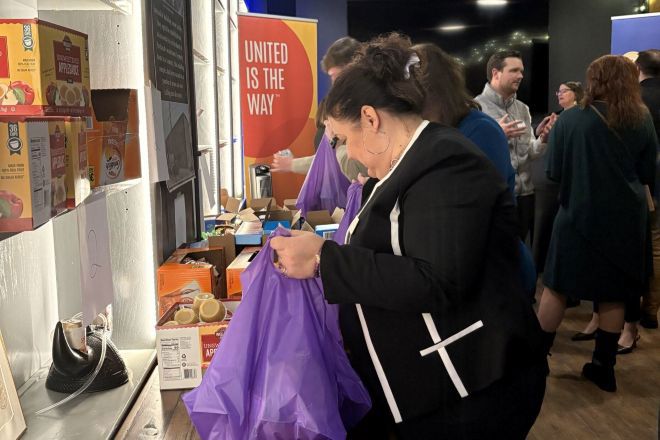 ELU Member packing a meal kit